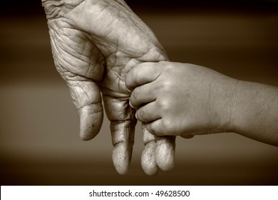 An old woman and a kid holding hands together