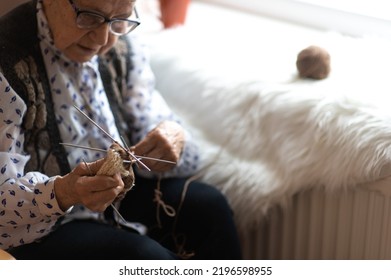 Old Woman Knitting In A Nursing Home By The Window