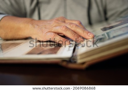 Old woman looking at family photo album