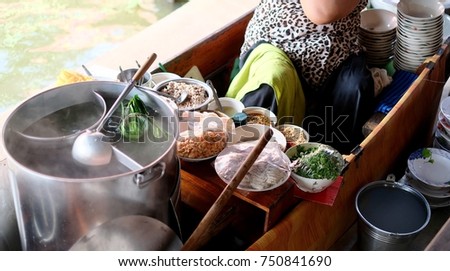 Old woman making the noodle in the boat (Kuay Tiew Ruer) This kind of food is very simple food as you can easy looking for every where in Thailand, famous food.