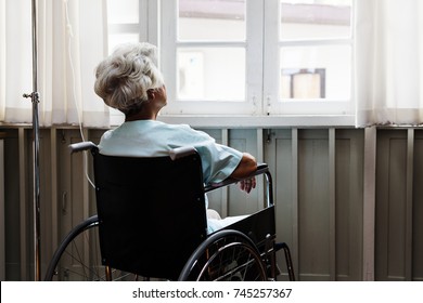 Old Woman On A Wheel Chair