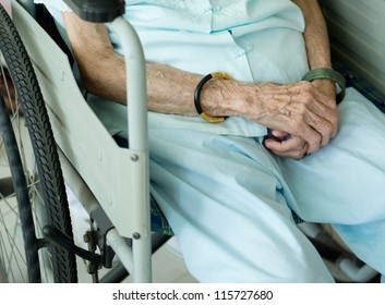 Old Woman On A Wheelchair.