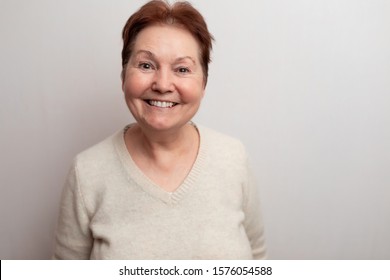 Old woman on a white background in a light sweater. Emotions - Shutterstock ID 1576054588