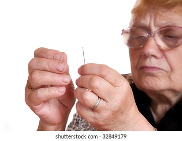 The Old Woman Passes  Thread In Needle On  White Background