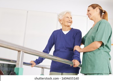 Old Woman With Physiotherapist At Exercise Therapy In Nursing Home