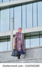 Old Woman With Pink Hair In Cashmere Coat And Hand Bag Walking