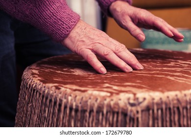 Old Woman Playing Bongo Drums