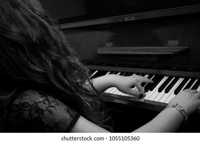 Old Woman Playing Piano In Black And White