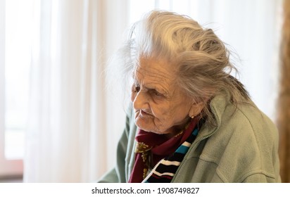 Old Woman. Portrait Of Very Old Tired Woman In Depression Standing Near The Window