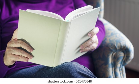 Old Woman Reading Book At Home