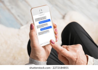 Old woman receiving scam messages on her mobile phone