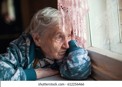 Old woman is sad emotions the home.