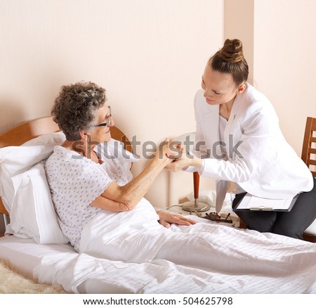 Similar – Caregiver auscultating senior woman