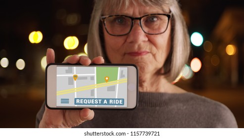 Old Woman Showing Phone Screen To Camera With Rideshare Application Open