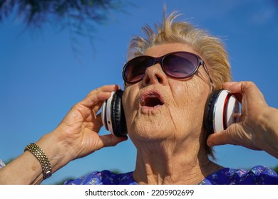 Old Woman Singing Music With Sunglasses And Headphone. Elderly Lifestyles