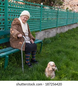 Old Woman Sitting On A Bench