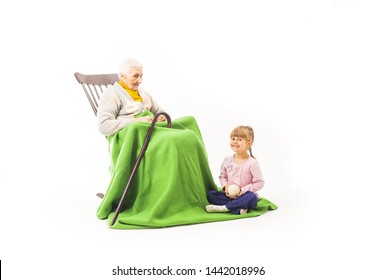 Old Woman Sitting On The Rocking Chair With Her Grandchildren