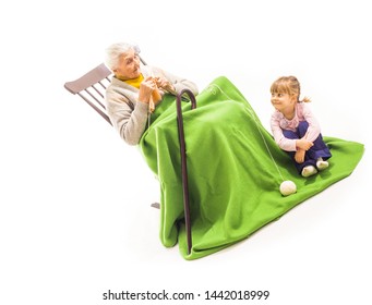 Old Woman Sitting On The Rocking Chair With Her Grandchildren