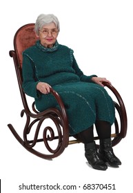 Old Woman Sitting On A Wooden Rocking Chair Isolated Against A White Background.