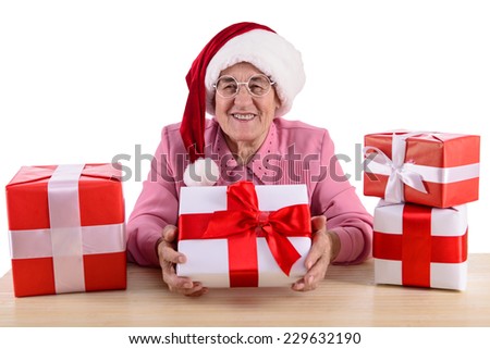 old woman sitting at the table with gift box. Isolated on white background
