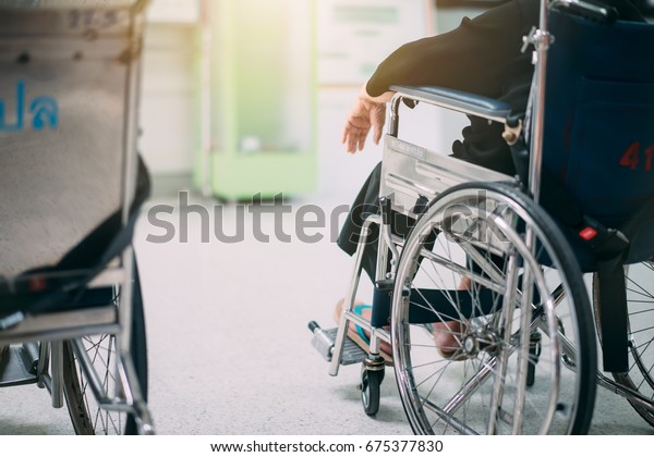 Old woman\
sitting in a wheelchair in the\
hospital.