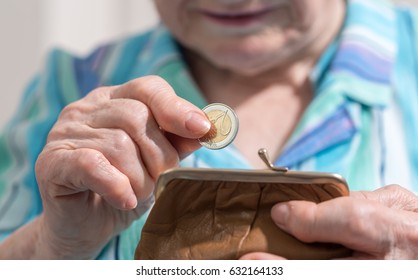 Old Woman Taking Out A Coin From Her Wallet