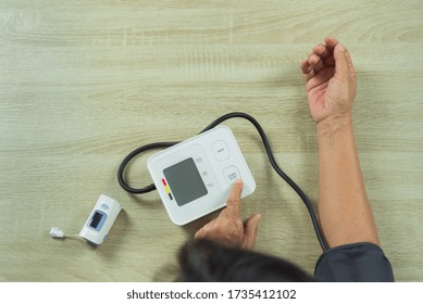 old woman with tonometer checking blood pressure level - Shutterstock ID 1735412102