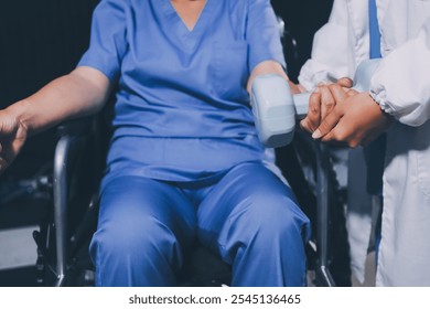 Old woman training with physiotherapist using dumbbells at home. Therapist assisting senior woman with exercises in nursing home. Elderly patient using dumbbells with outstretched arms. - Powered by Shutterstock