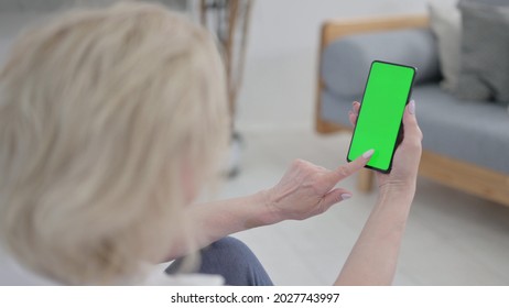 Old Woman Using Smartphone with Green Screen on Excercise Mat - Powered by Shutterstock