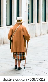 Old Woman Walking With Cane In Venice Italy