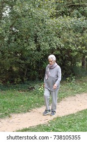 Old Woman Walking In A Park