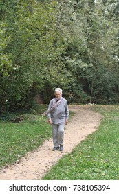 Old Woman Walking In A Park