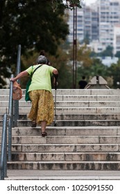 Old Woman Walking Up The Stairs