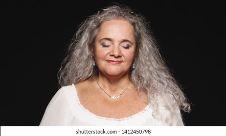 Old Woman In White Hair Isolated On Black Background With Closed Eyes. Close Up Of Senior Woman With Closed Eyes.