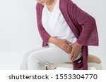 The old woman who has a pain in a hip joint