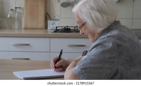 Old woman is writing letter or the last will - Powered by Shutterstock