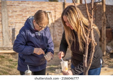 Old Woman With Young Woman Eating Yogurt In The Afternoon.family Eating Dessert