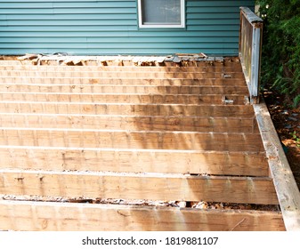 The Old Wood Of A Backyard Deck Has Been Removed To Install Composite Material Deck On Top.