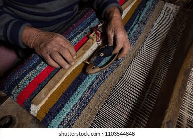 Old Wood Carpet Weaving Machine Manual And Old Workshop Man Makes A Abstract Carpet By Hand. 