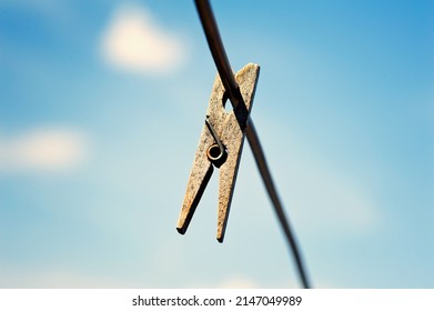 Old Wood Clothespin Hanging On A Line With Copy Space Place.