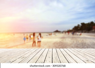 Old Wood Floor On Beach With Blur People On Beach Background.