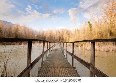 Old Wood Footbridge On Lagoon. Outdoor And Nature. Rural Panorama