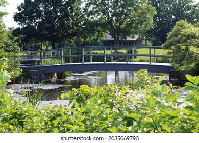 The Old Wood Footbridge In The Park On A Sunny Day.