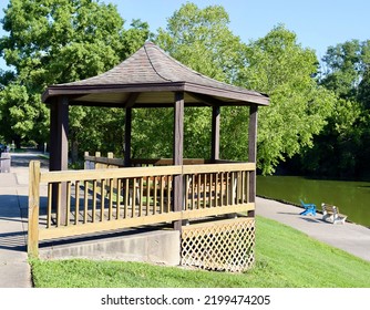 The Old Wood Gazebo In The Park On A Sunny Day.
