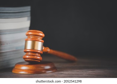 Old Wood Judge Hammer With Law Book On The Table Wood Background, Used For Adjudication And Justice.