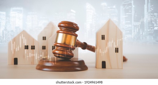 Old wood Judge hammer with Mini wood house model from model on wood table, Planning buy Real Estate, Planning to buy property and Choose the best, financial liabilities concept.