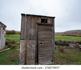 A old wood outhouse on a cattle ranch.