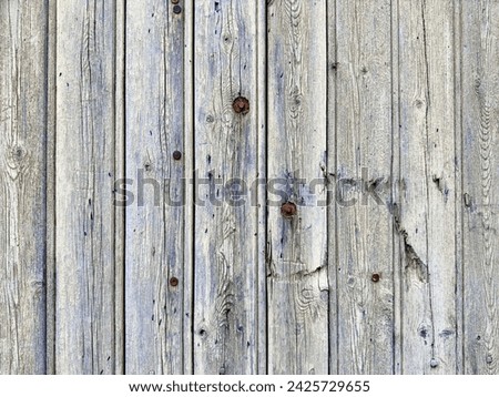 Old wood panel background with rusted bolts with old weathered blue paint