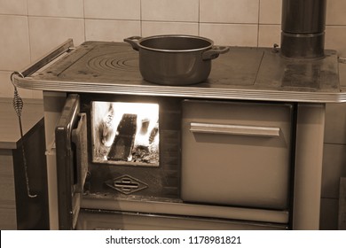 Old Wood Stove With Fire In The Kitchen With Sepia Effect