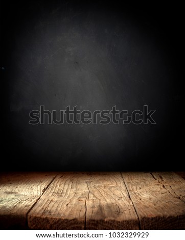 Old wood table top with smoke in the dark background.